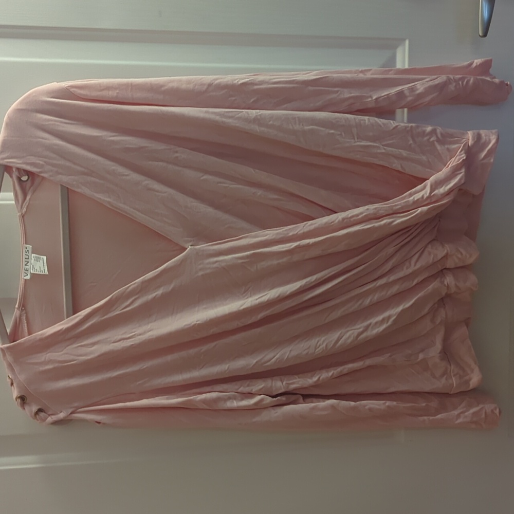 Cold shoulder light pink cute top with a deep v neck.